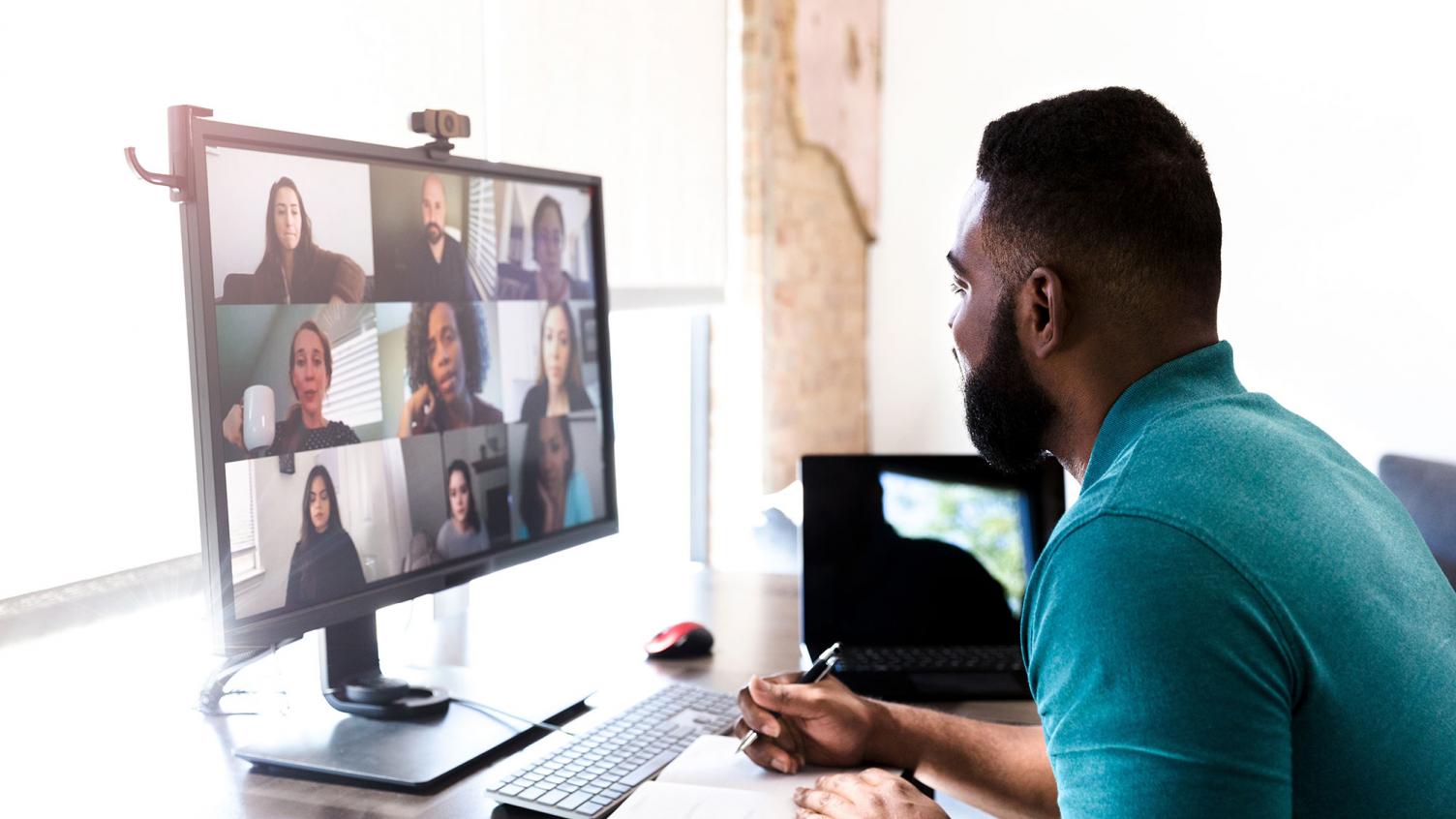 Home worker taking notes video call